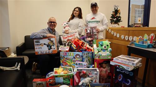 Principal Obed Morales, Student Vanesa Lopez, Sen. Sal DiDomenico with toys donated for Vanesa's Toy Drive
